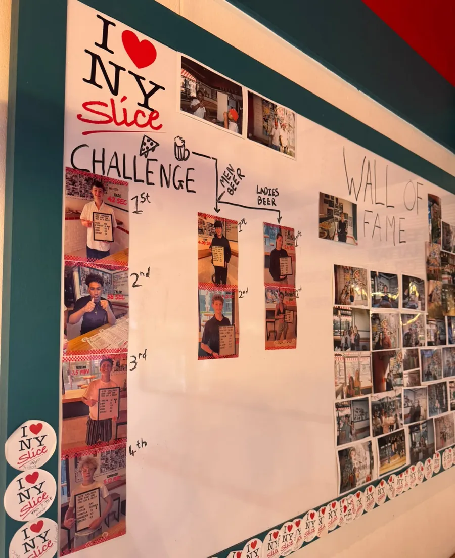 An NY Slice Challenge wall: polaroids of the fastest eaters, ranked first to fourth