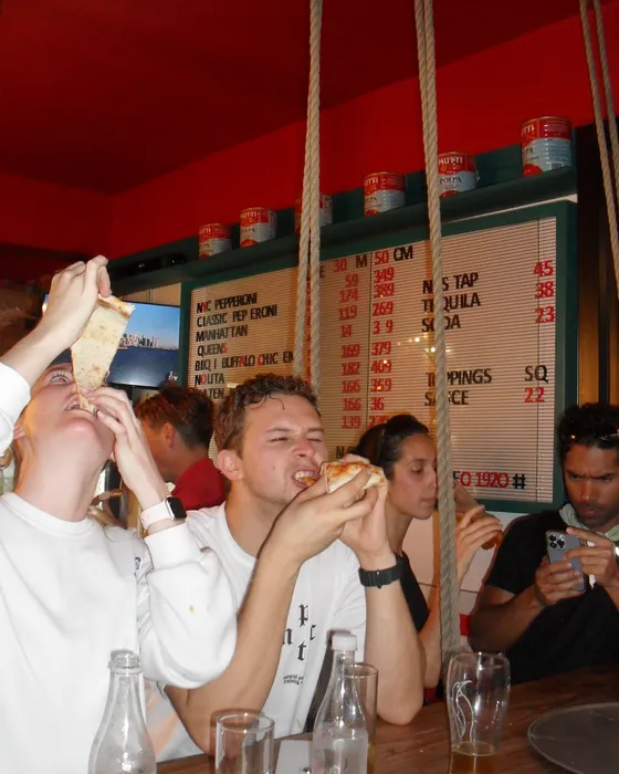 Runners eating slices at the counter