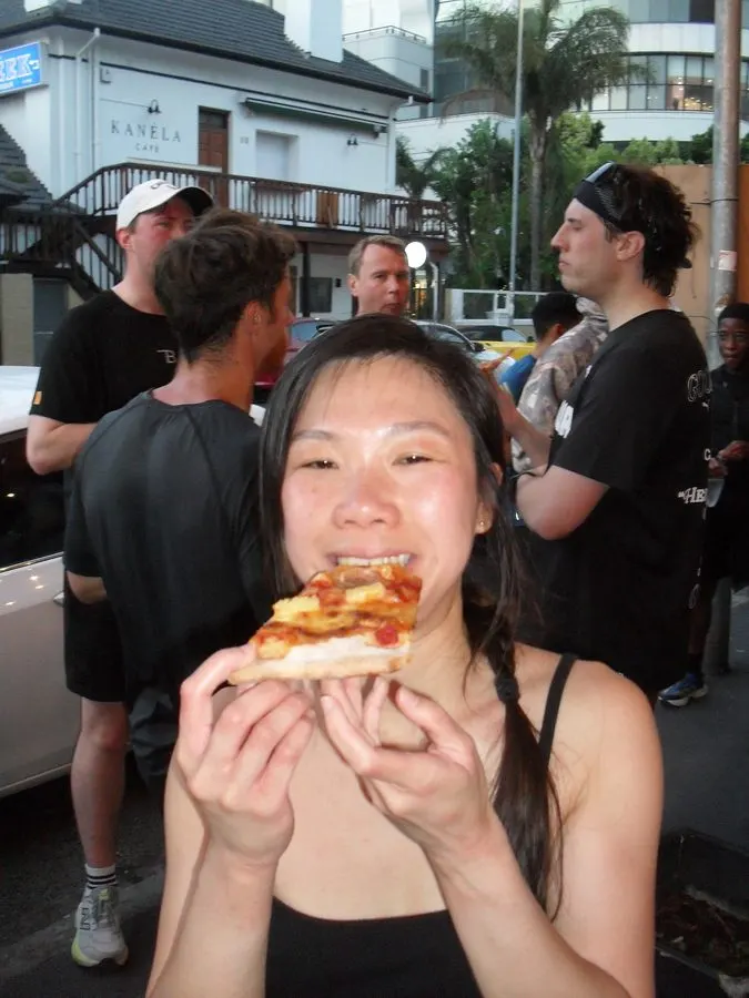 A runner eating a slice after the run